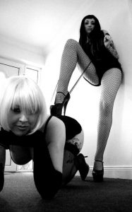 dominatrix domme with slave girl on leash stockings fishnets